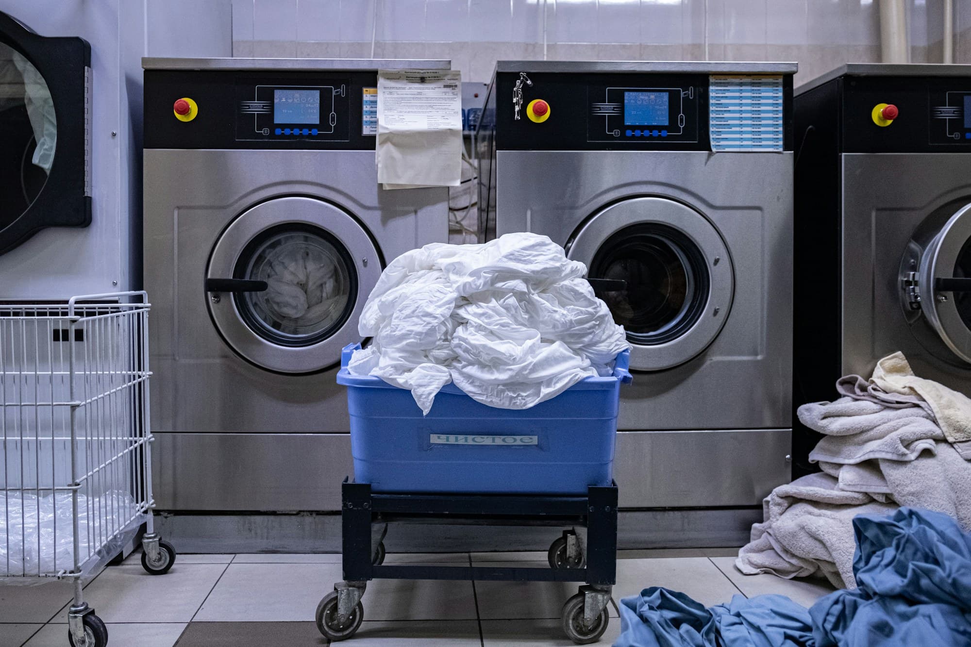 Commercial washing machines running inside the laundromat