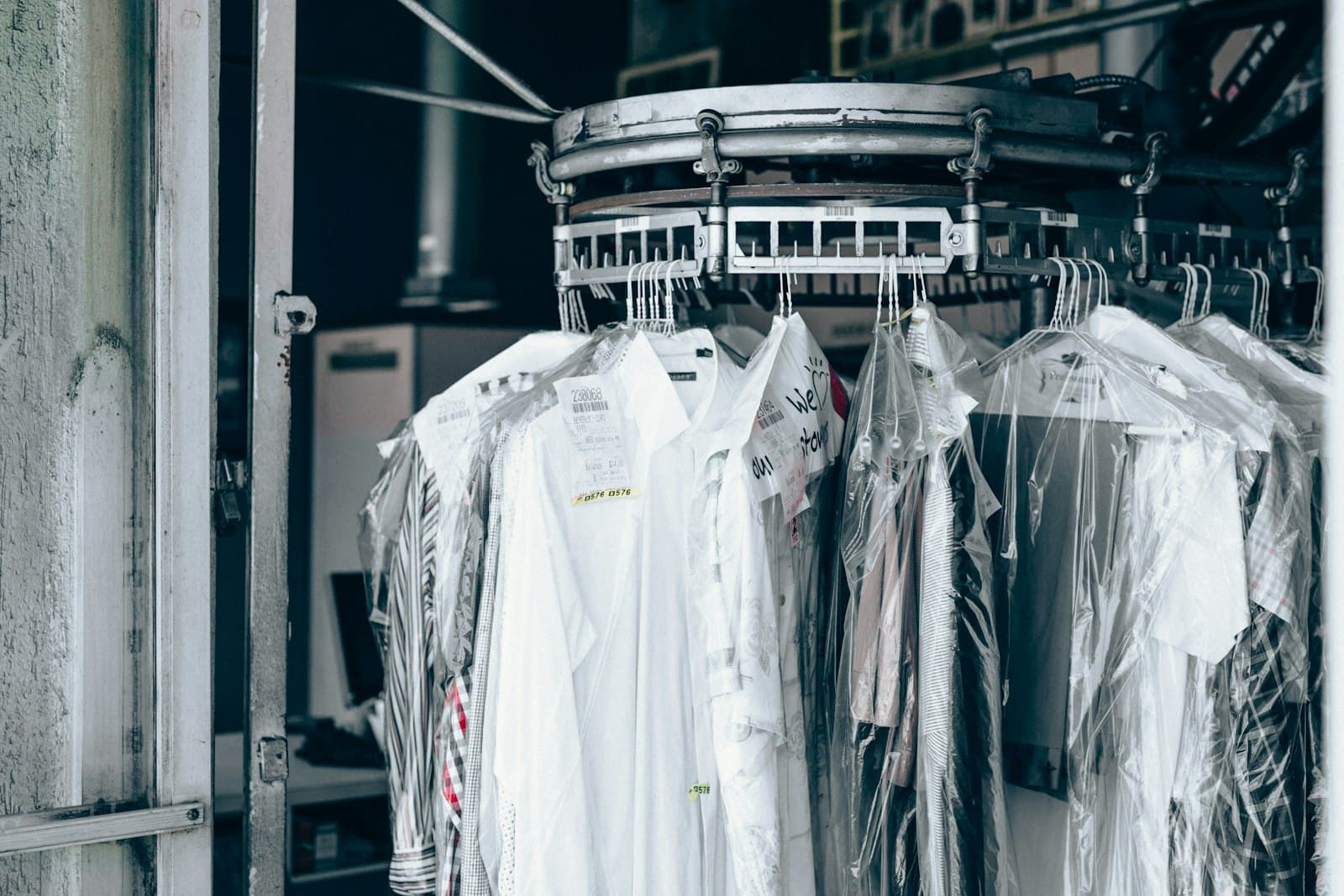 Dry cleaned garments hanging in protective covers